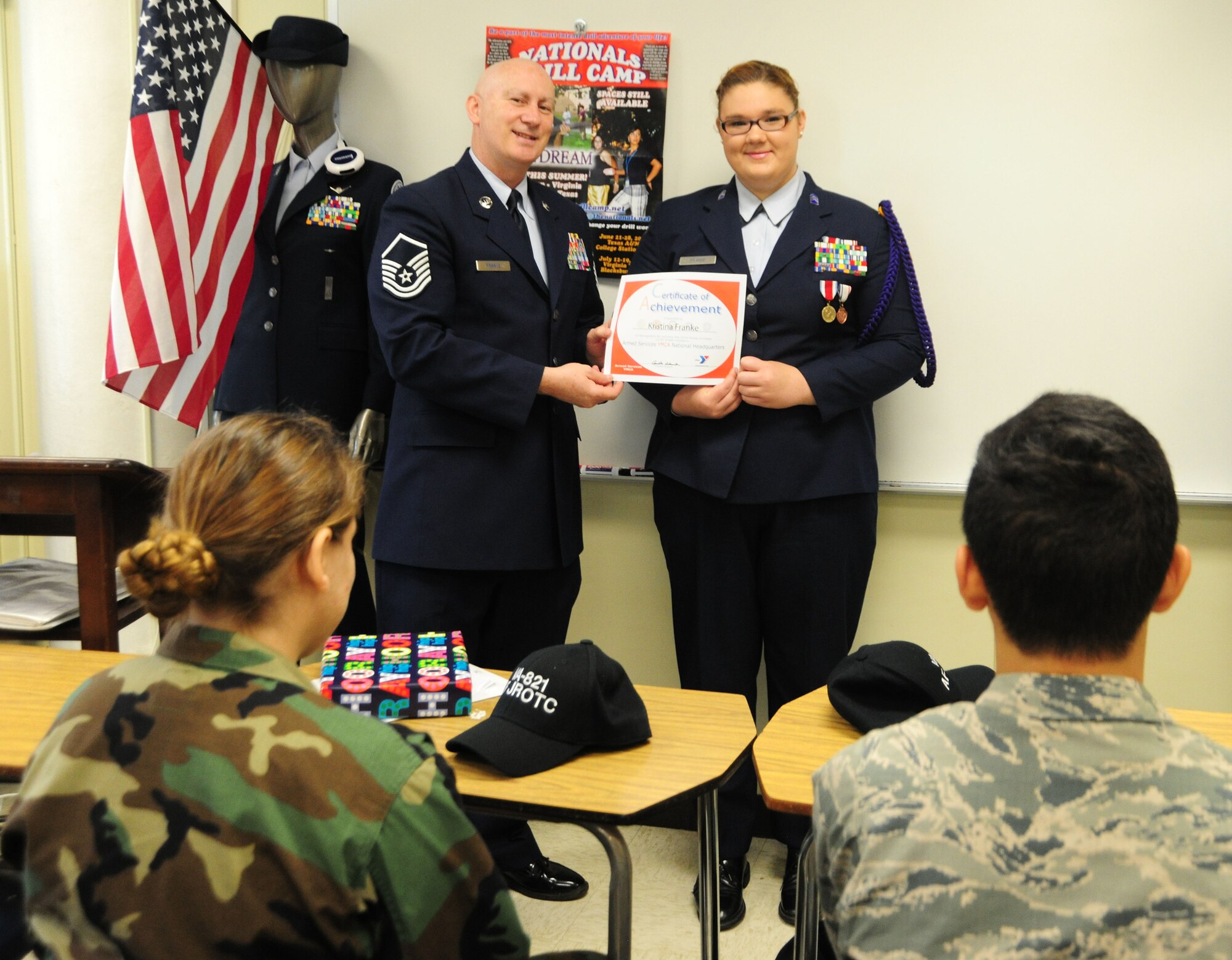 Master Sgt. John Franke and his daughter, Air Force JROTC Cadet Lt. Kristina Franke, hold her certificate of achievement for winning the Armed Services YMCA National Essay Contest on May 15, 2014, at the Arlington Career Center, Va. Kristina's essay said her father Franke, Joint Base Andrews, Md., 11th Security Forces Group superintendent of resources, is her military hero. (U.S. Air Force photo/ Staff Sgt. Amber J. Russell)