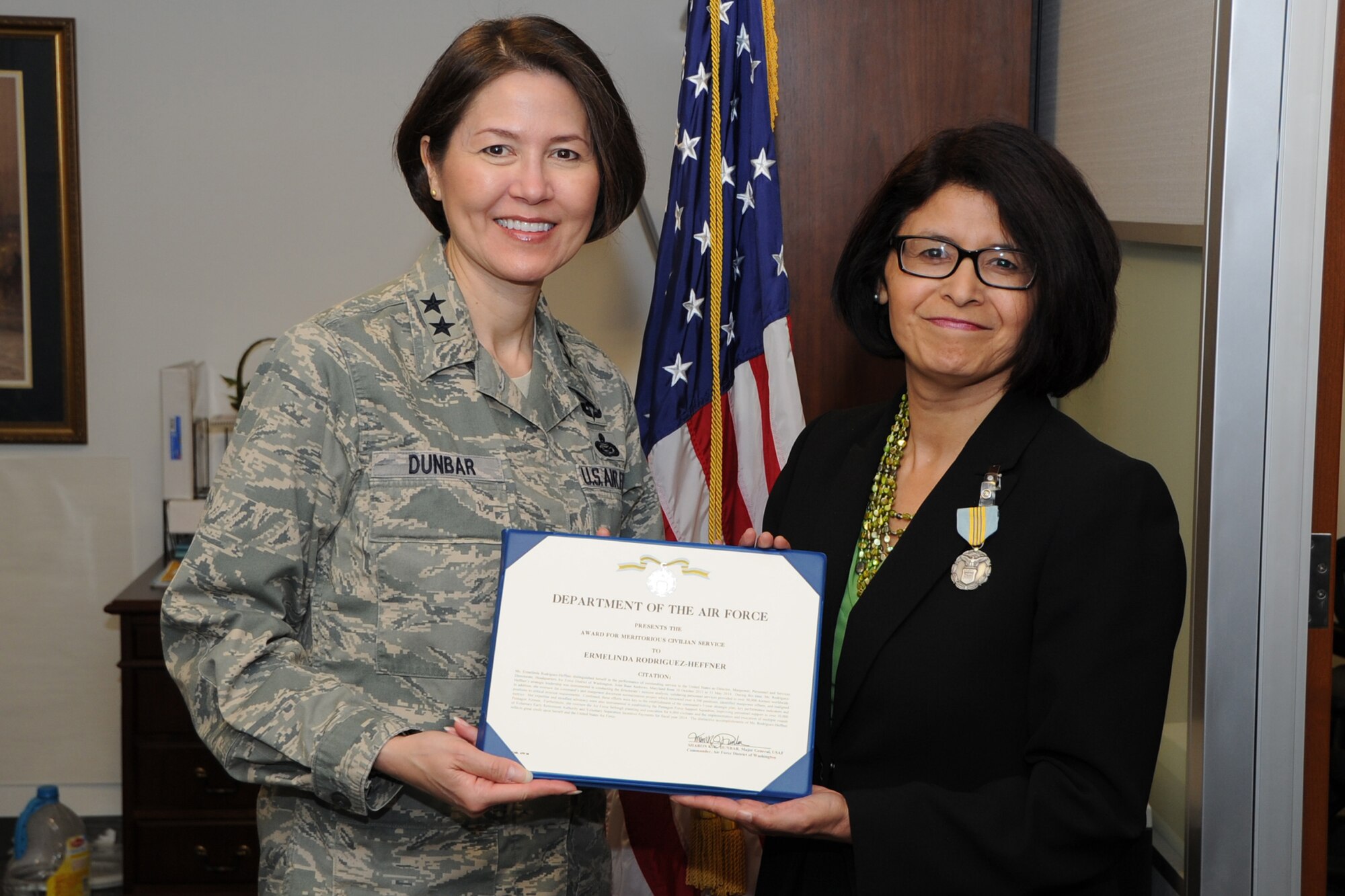 Air Force District of Washington Commander Maj. Gen. Sharon K. G. Dunbar presents the Award for Meritorious Civilian Service to Ermelinda Rodriguez-Heffner, AFDW A1 director, at Joint Base Andrews, Md., May 22, 2014. The Meritorious Civilian Service Award is the second highest award presented to federal civilian employees. (U.S. Air Force photo/Staff Sgt. Matt Davis)