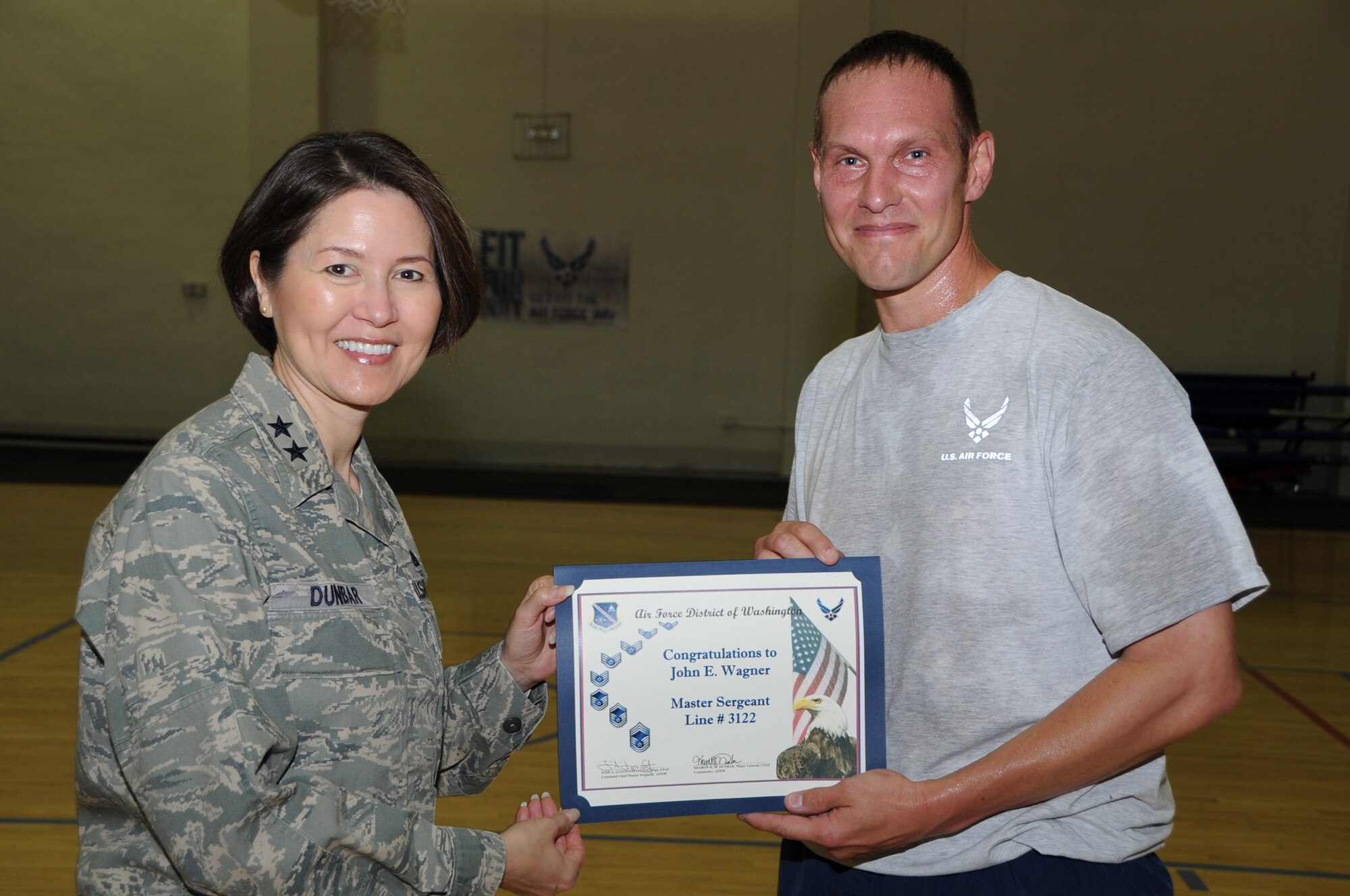 Air Force District of Washington Commander Maj. Gen. Sharon K. G. Dunbar presents a promotion line number to Technical Sgt. John Wagner, AFDW A3, for the rank of Master Sergeant at Joint Base Andrews, Md., May 22, 2014. Wagner was greeted by all AFDW leadership and Senior NCOs to congratulate him on his promotion. (U.S. Air Force photo/Staff Sgt. Matt Davis)