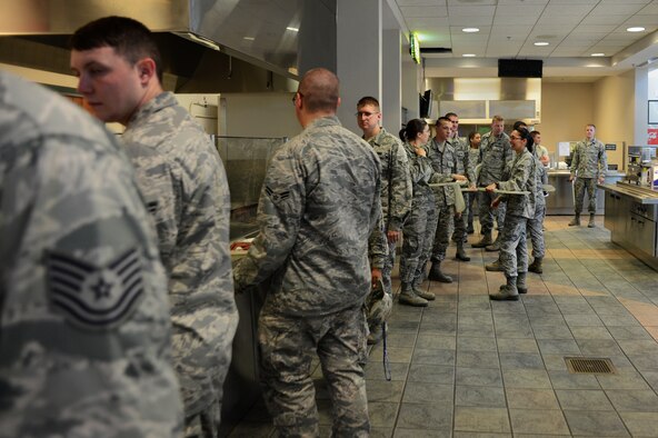 Airmen from across the 20th Fighter Wing wait in line to get food during the Airman Appreciation dinner at the Chief Master Sgt. Emerson E. Williams dining facility at Shaw Air Force Base, S.C., May 21, 2014. Squadron commanders and first sergeants came to the DFAC and ate dinner with Airmen who live in the dorms. (U.S. Air Force photo by Airman 1st class Jonathan Bass/Released)
