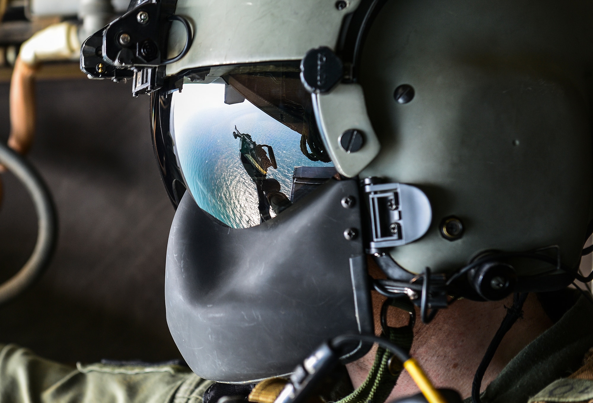 Tech. Sgt. Kevin Smith, 8th Special Operations Squadron flight engineer, scans the local area during a CV-22 Osprey training flight May 20, 2014. Flight engineers perform multiple roles during flight including tail scanning. (U.S. Air Force photo/Airman 1st Class Jeff Parkinson)