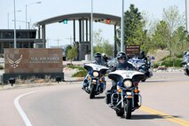 SCHRIEVER AIR FORCE BASE, Colo. -- Approximately 50 police and civilian riders from various locations throughout the front range exit Schriever's north gate after a quick transit through the base on 22 May.  The ride was in honor of Police Week and Law Enforcement Officers who have lost their lives in the line of duty. (U.S. Air Force Photo/Dennis Rogers)