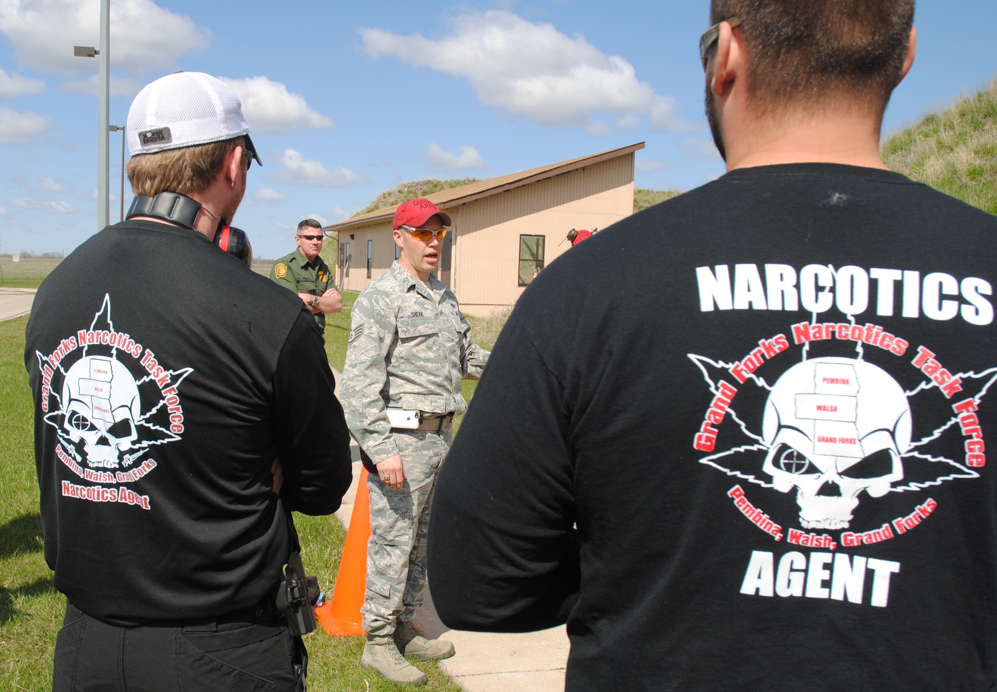 Members from the Grand Forks Narcotics Task Force shooting team and other competitors listen to 319th Security Forces Squadron Combat Arms instructor Staff Sgt. Randy Shear, give final instructions for the start of the 2014 Police Week Commanders’ Shoot on May 15, 2014, at the grounds of the firing range at Grand Forks Air Force Base, N.D. The shooting competition was one of seven events hosted by 319th SFS as part of their observance of National Police Week. (U.S. Air Force photo/Staff Sgt. Luis Loza Gutierrez)
