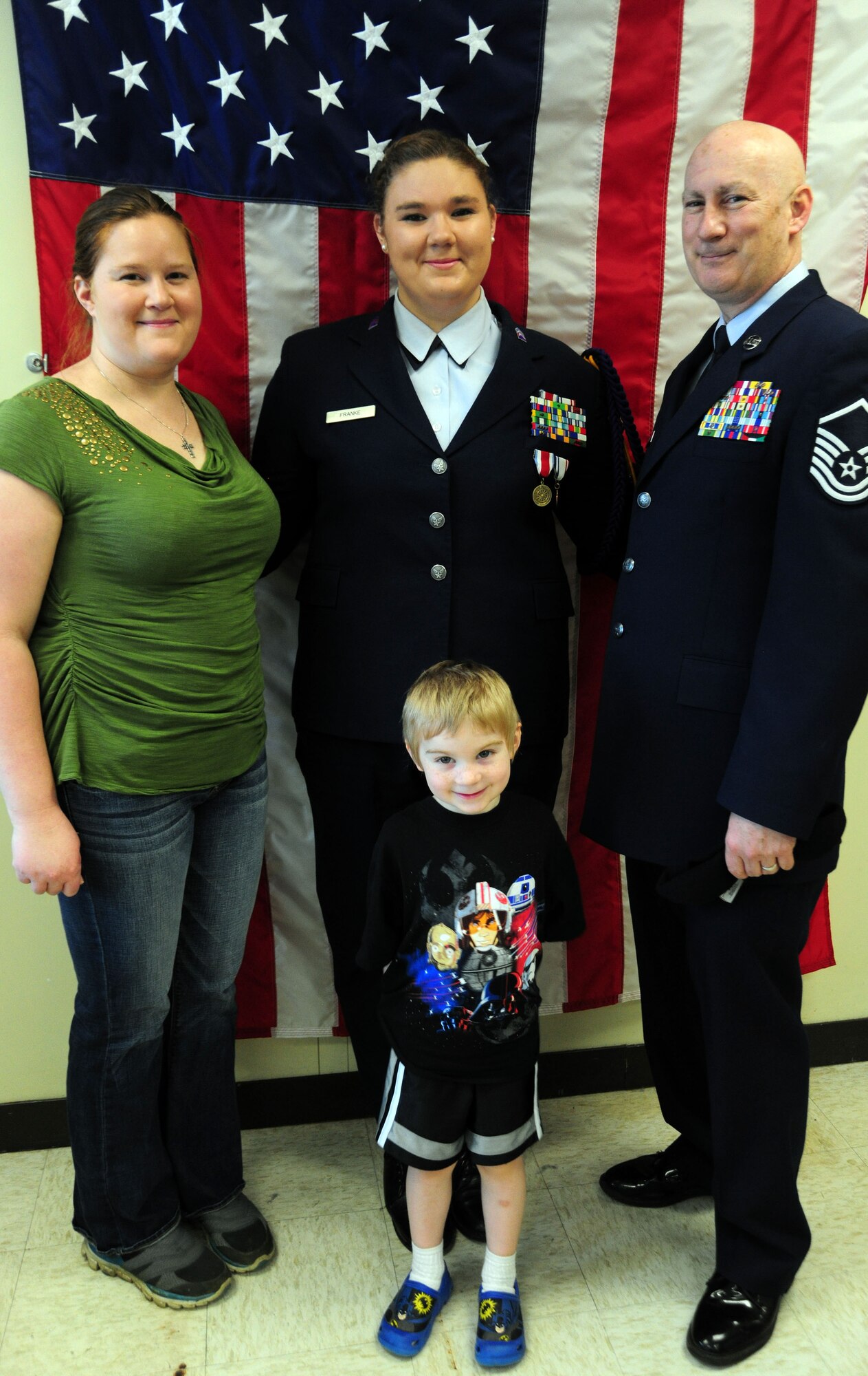 Master Sgt. John Franke and his wife Stephanie, stand with their young son and daughter, Air Force JROTC Cadet, Lt. Kristina Franke, after she won the Armed Services YMCA National Essay Contest on May 15, 2014, at the Arlington Career Center, Va. According to her essay, her father, 11th Security Forces Group superintendent of resources, is her military hero. (U.S. Air Force photo/ Staff Sgt. Amber J. Russell)