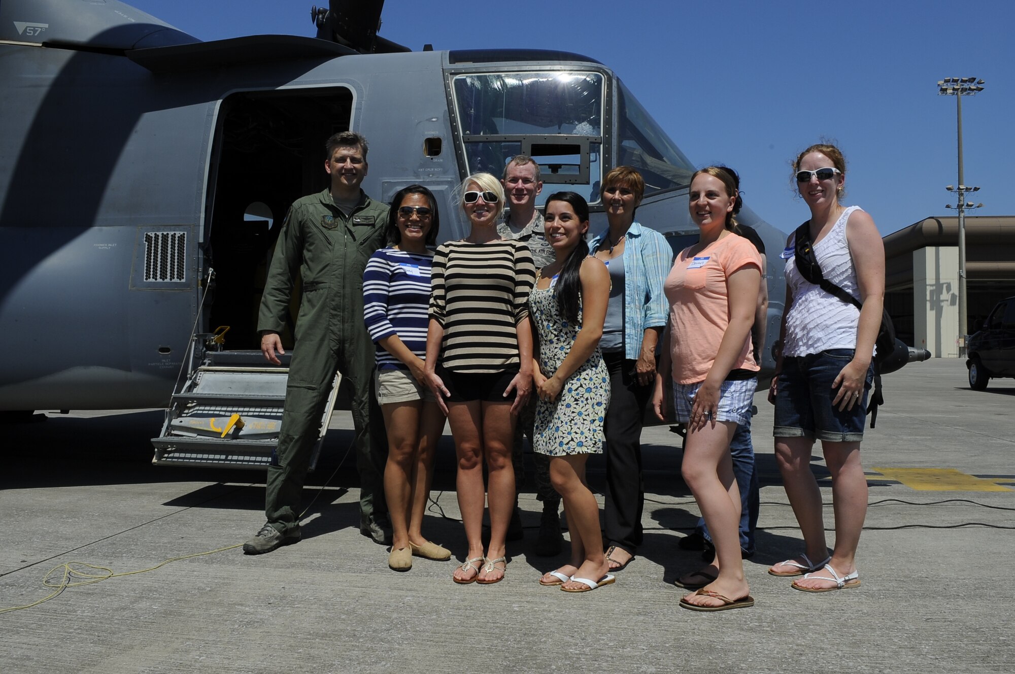 Spouses pose for a group photo with Col. William West, 1st Special Operations Wing commander, in front of a CV-22 Osprey at Hurlburt Field, Fla., May 21, 2014. The group toured the flightline to learn about the base’s mission. (U.S. Air Force photo/Airman 1st Class Andrea Posey)