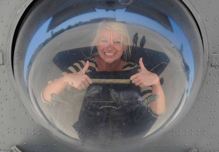 Cortni Bird looks through a window on the AC-130 gunship during a spouse’s tour on Hurlburt Field, Fla., May 21, 2014. Spouses toured the flightline with Col. William West, 1st Special Operations Wing commander.  (U.S. Air Force photo/Airman 1st Class Andrea Posey)