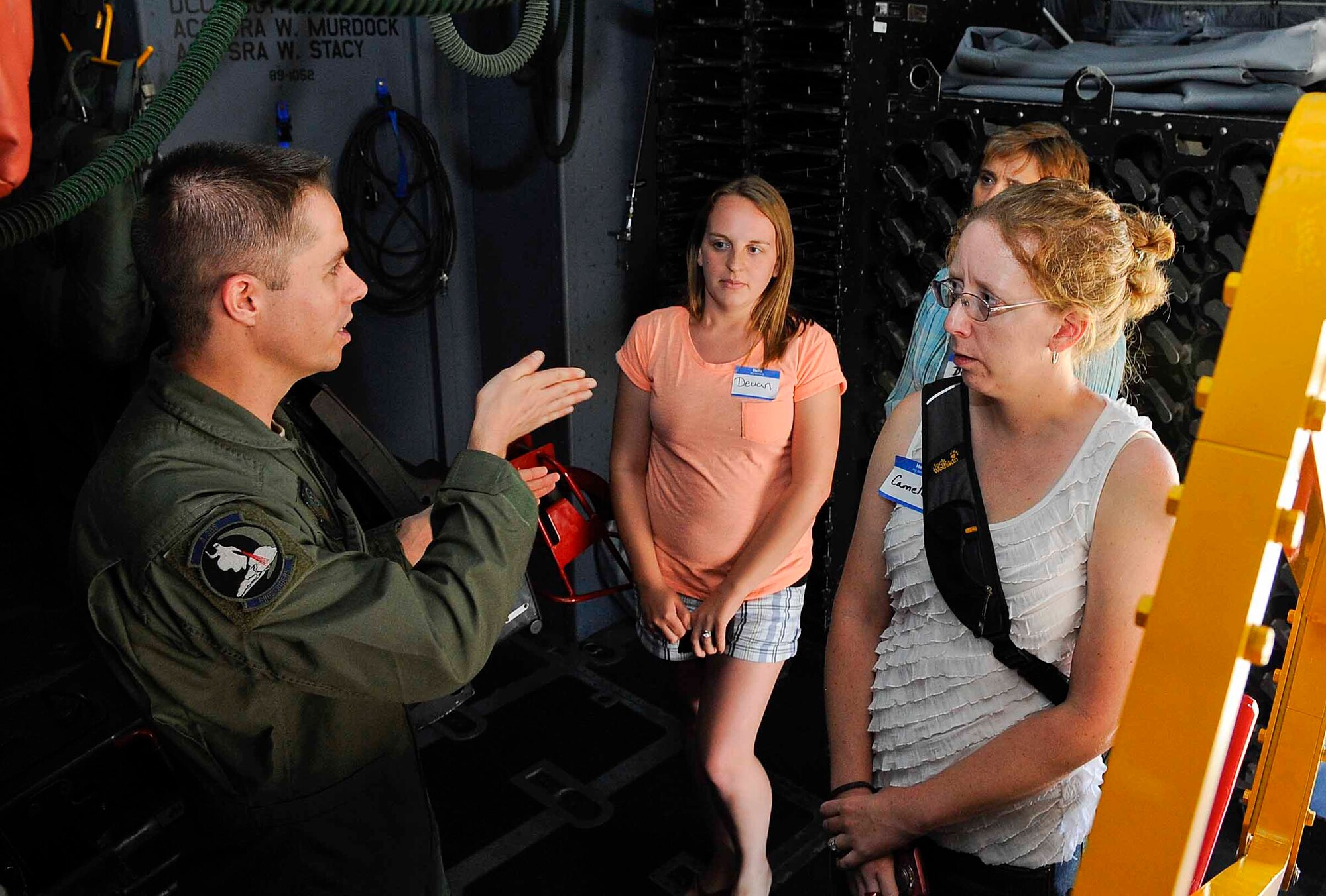 Staff Sgt. William Collier, 4th Special Operations Squadron aerial gunner, briefs spouses during a tour on an AC-130 gunship on Hurlburt Field, Fla., May 21, 2014. The tour allowed military spouses to explore the base with Col. William West, 1st Special Operations Wing commander. (U.S. Air Force photo/Airman 1st Class Andrea Posey)