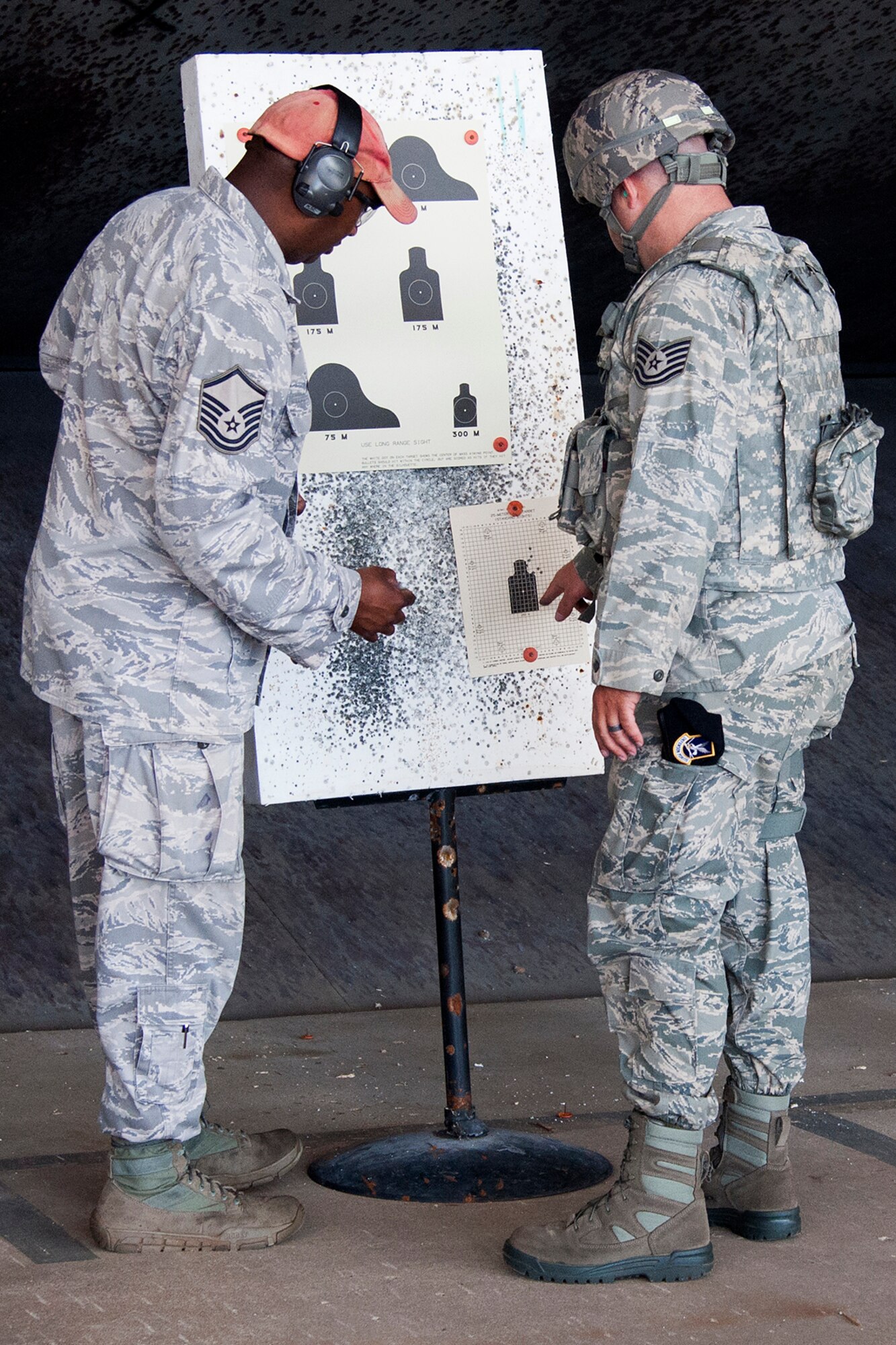 An Airman assigned to the 307th Security Forces Squadron looks over his bullet grouping to see what adjustments need to be made during weapons qualification training, May 17, 2014, Barksdale Air Force Base, La. This is required training for the Airman who is preparing to deploy in support of an Eager Lion exercise. (U.S. Air Force photo by 2nd Lt. Monique Roux/Released)