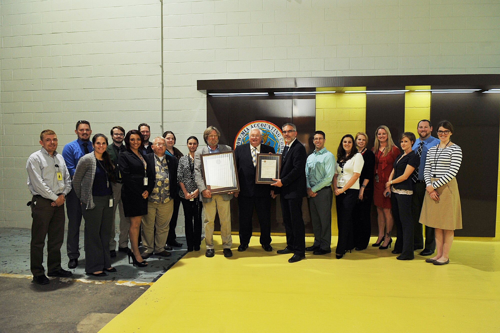 Members of the Joint POW/MIA Accounting Command CONUS Annex pose for a photo outside of their facility May 14 following a ceremony to officially announced they had passed accreditation by the American Society of Crime Lab Directors / Laboratory Accreditation Board. Ralph M. Keaton, in the middle of the photo, who is a founding member of the ASCLD and was a member of the committee which developed the original accreditation program that became ASCLD/LAB, spoke at the ceremony and presented the team with their certificate. (U.S. Air Force photo by Charles Haymond/Released)