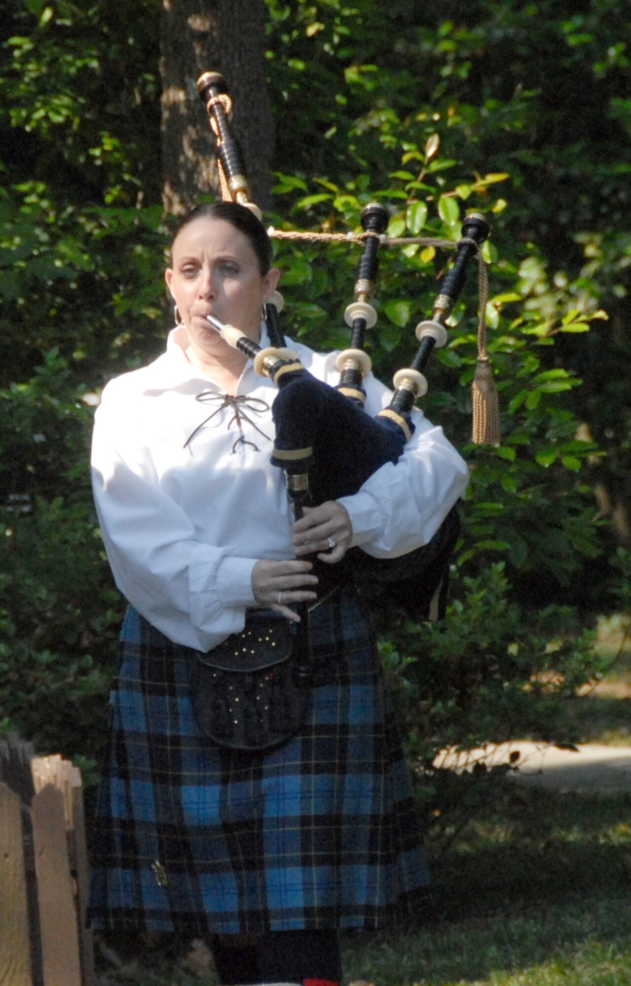 Retired Master Sgt. Mary Spano plays “Amazing Grace” on bagpipes during the memorial service at Camellia Gardens Thursday, May 22. (U.S. Air Force photo by Misuzu Allen)