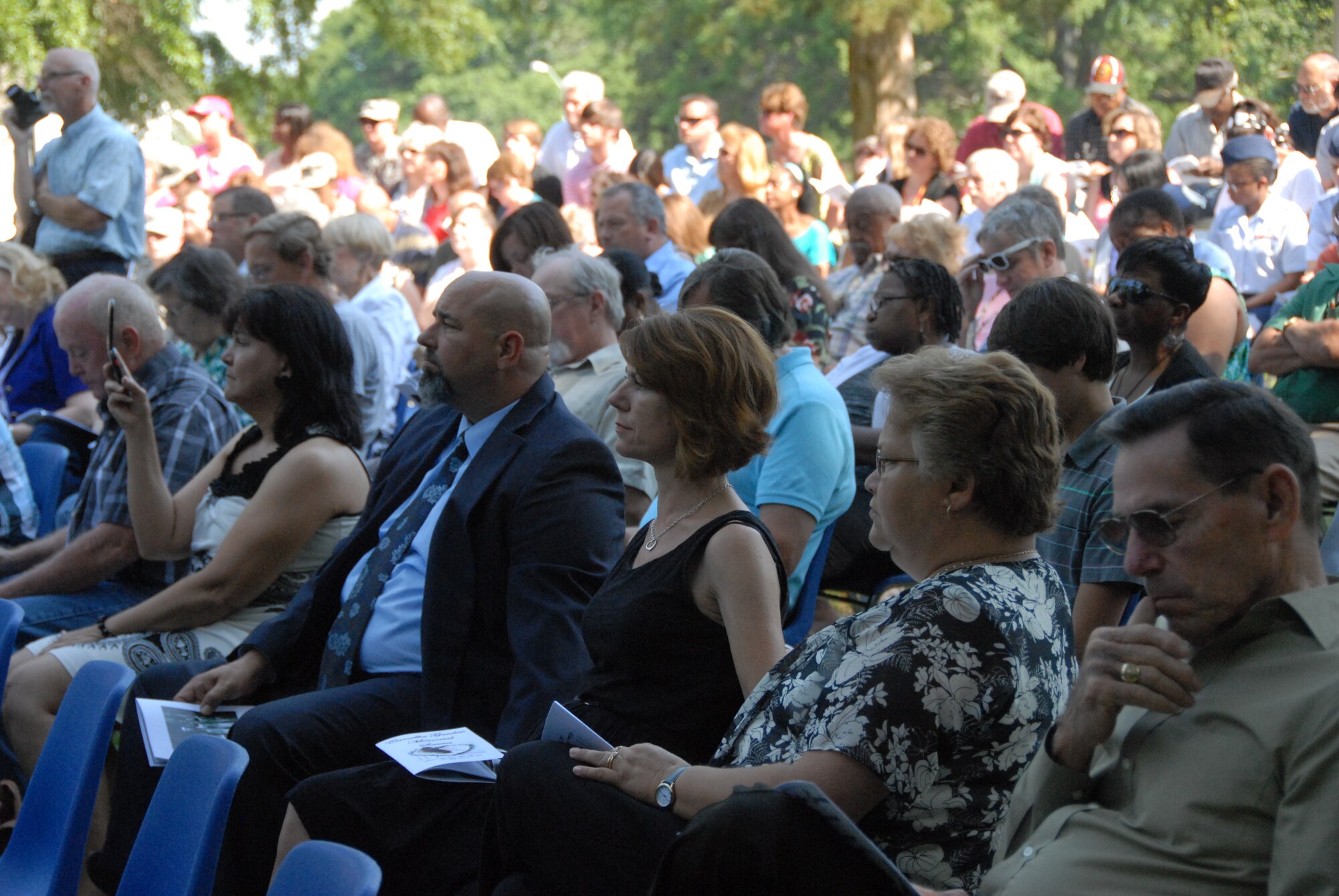 Friends and family of Team Robins members who have lost their lives over the past year pay their respects during the Camellia Gardens Memorial Service Thursday, May 22.  (U.S. Air Force photo by Misuzu Allen)