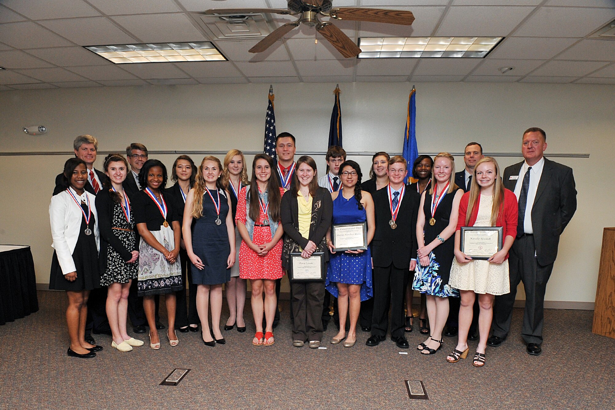 Congressional award winners pose with Reps. Jeff Fortenberry and Lee Terry, Nebraska congressmen, Col. Gregory Guillot, 55th Wing commander and Jeff Rippe, Bellevue Public Schools assistant superintendent, following an awards program May 16 at the Bellevue Public Schools Welcome Center. Sixteen young adults were presented with medals and certificates as part of the Congressional Awards Program, which encourages young people to set and achieve goals in four areas: volunteer public service, personal development, physical fitness and expedition/exploration activities. (U.S. Air Force photo by Charles Haymond/Released)