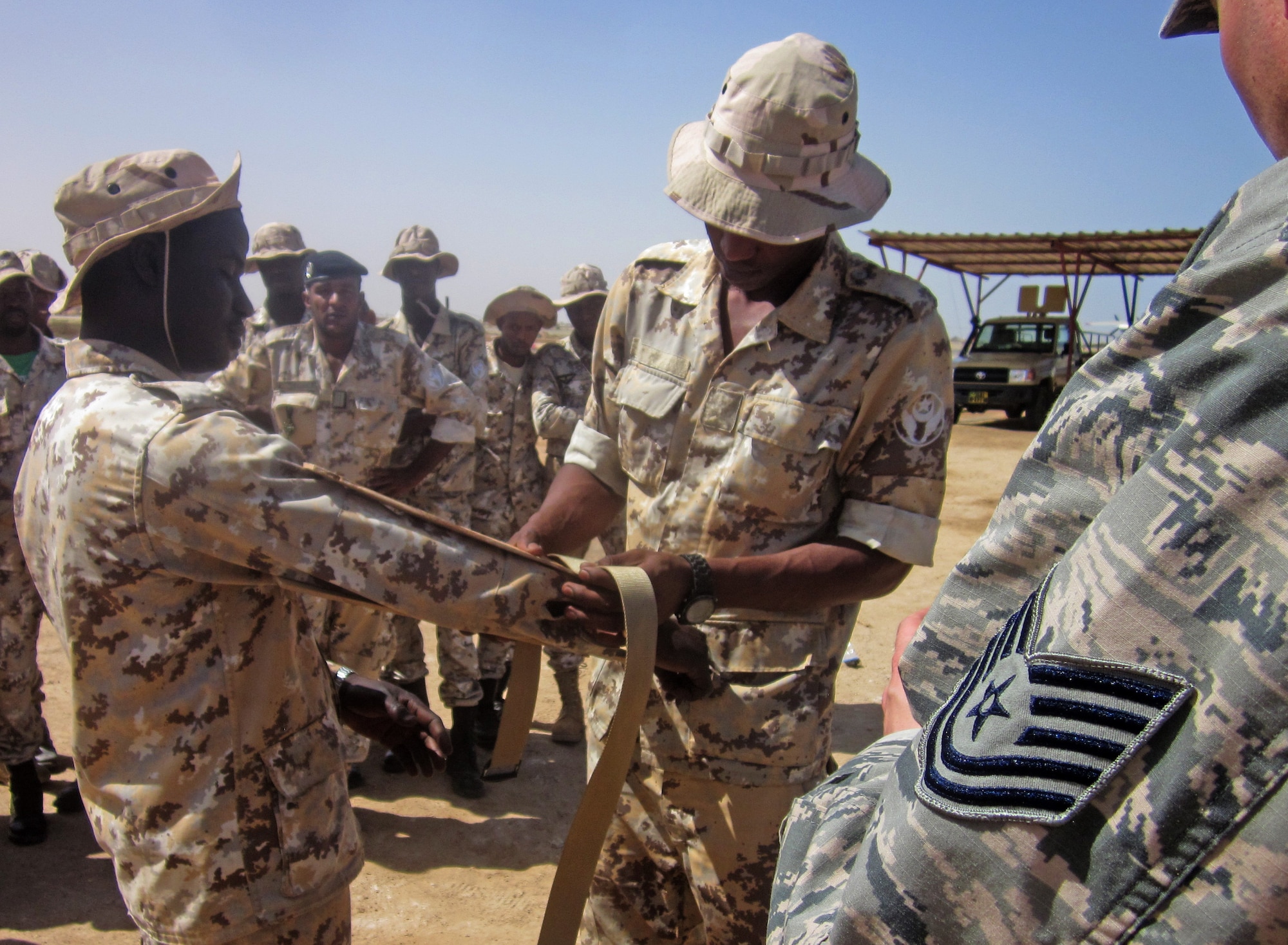 NOUAKCHOTT AIR BASE, Mauritania -- Tech. Sgt Julio Figueroa, 818th Mobility Support Advisory Squadron air advisor, looks on as Mauritanian Airmen practice self-aid buddy care at Nouakchott Air Base, Nouakchott, Mauritania, April 24, 2014. This marked the third engagement for the MSAS in Mauritania. (Courtesy photo)