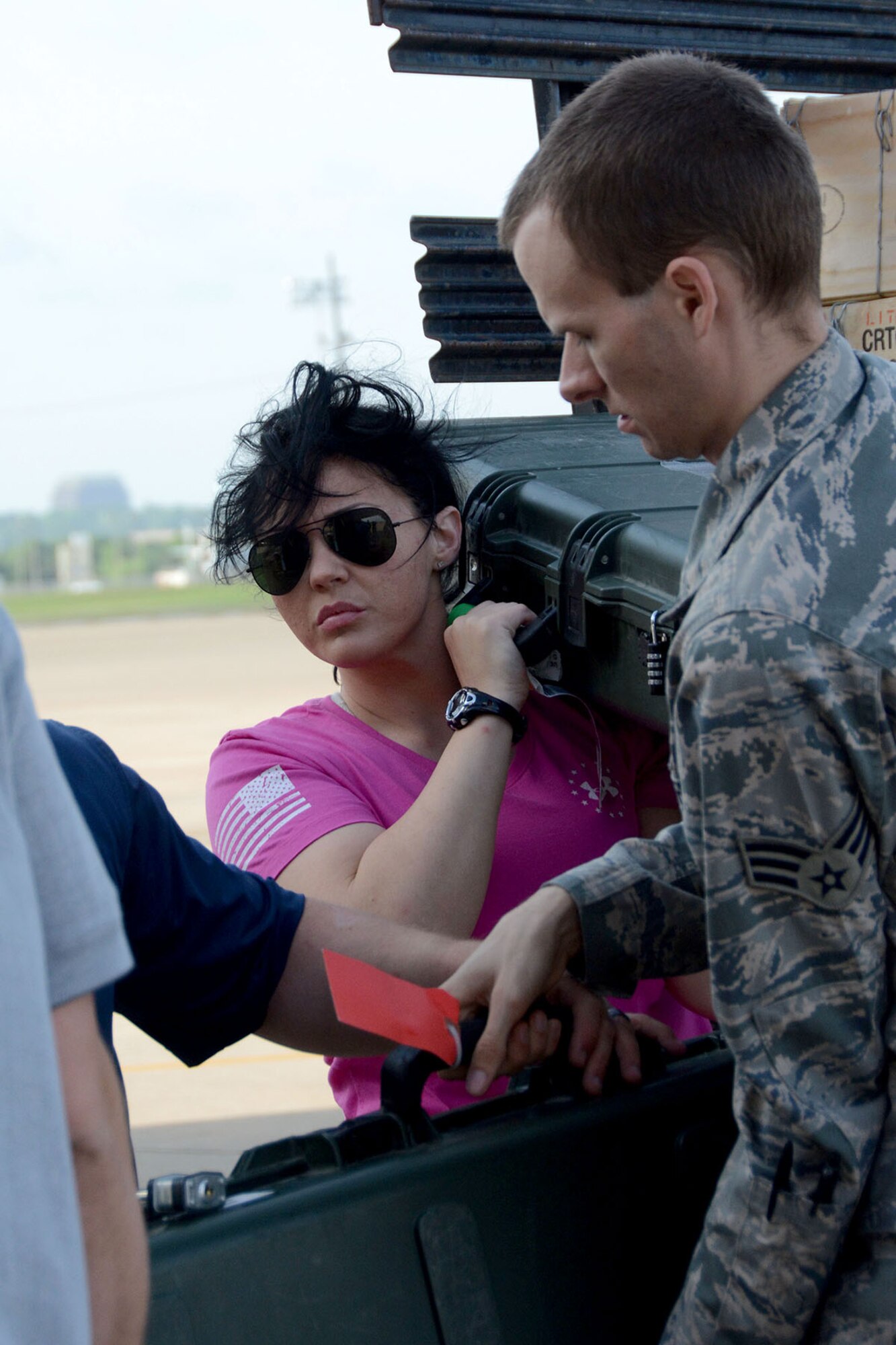 U.S. Air Force Senior Airman Cherish Dangerfield, who is a fire team member assigned to the 307th Security Forces Squadron, helps unload baggage from a flatbed truck to a waiting jet at the Naval Air Station Joint Reserve Base, Ft. Worth, Texas, May 20, 2014. Approximately 60 Airmen from 307th, 301st and 610th Security Forces Squadrons left to take part in the annual multi-national exercise Eager Lion. These Reserve Airmen will join other U.S. military members in an exercise that includes more than 20 nations and approximately 12,500 troops. (U.S. Air Force photo by Staff Sgt. Samantha Mathison)