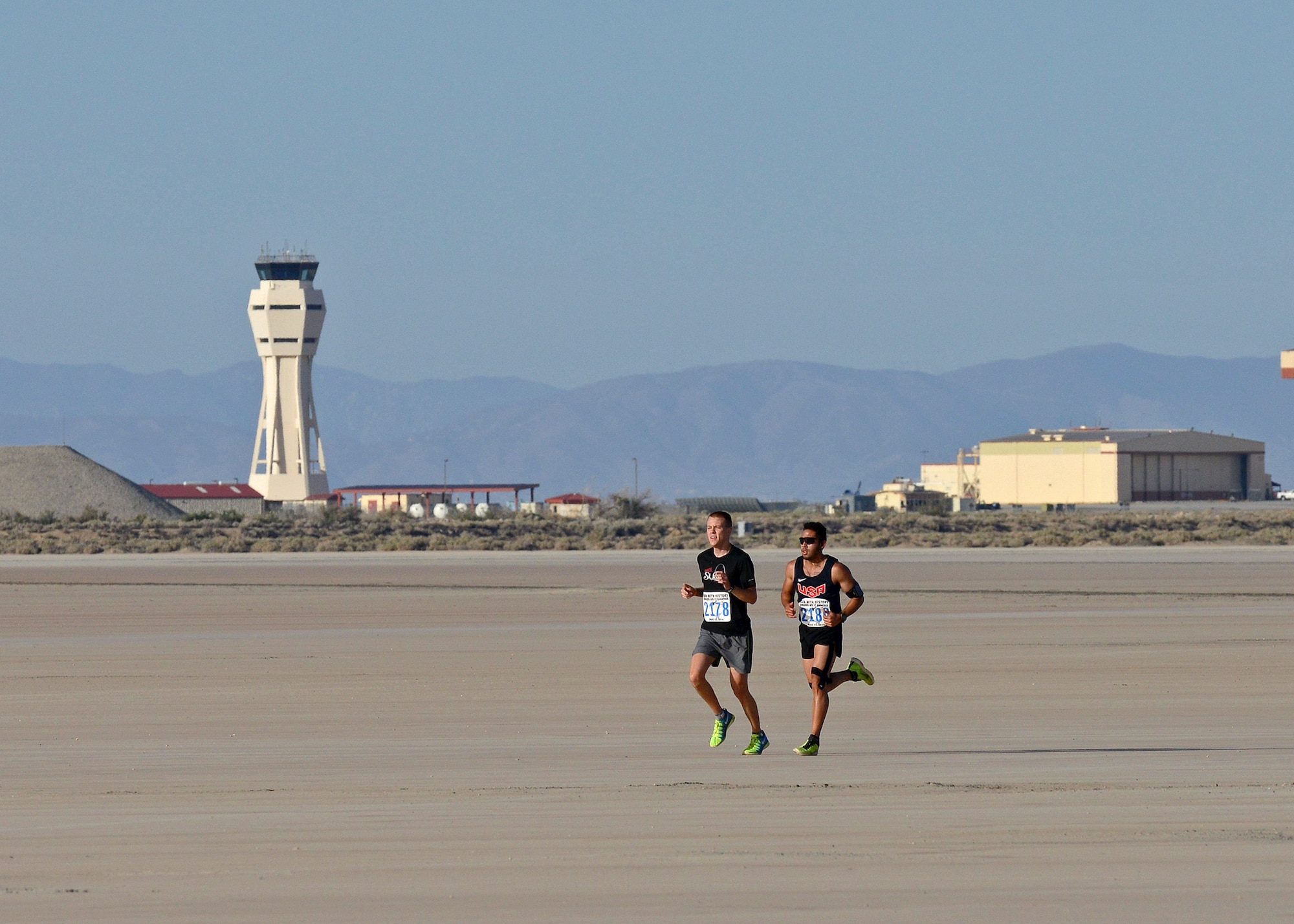 Two runners reach the Rogers Dry Lakebed during the 2014 Edwards Inaugural "Run with History" Half Marathon held May 17. Of the 500 runners who registered, 462 showed up to run and the event had approximately 200 spectators. (U.S. Air Force photo by Jet Fabara)