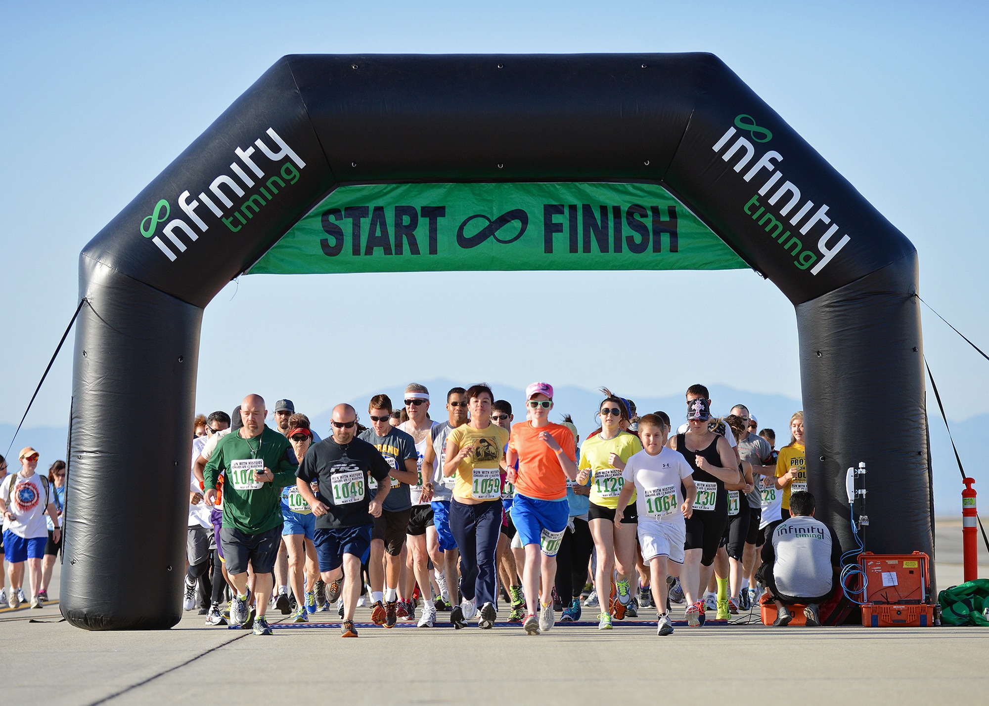 Runners take off from the start line for the 2014 Edwards Inaugural "Run with History" 5K run on May 17 on the Edwards flightline. Approximately 462 participants showed up to run and the event had approximately 200 spectators. (U.S. Air Force photo by Jet Fabara)
