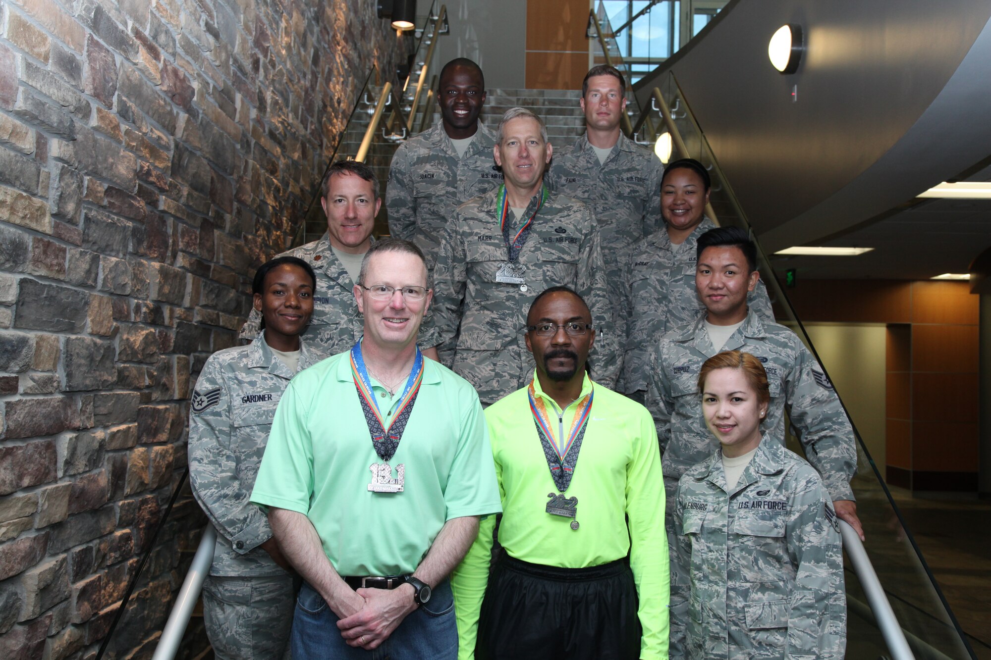 Some of the runners and volunteers from the Air Reserve Personnel Center who participated in the 9th annual Kaiser Permanente Colfax Marathon in Denver May 18, 2014, are Senior Airman Evan Joacin, Staff Sgt. Matthew Faini, Maj. Trent Champion, Senior Master Sgt. Brian Marr, Sgt. Alexis McCray, Martin White, Staff Sgt. Diaydra Gardner, Robert Scott, Staff Staff Sgt. Abrillo Corpuz and Senior Airman Myra Schulenburg. More than 17,000 runners took part in the event, which offers seven races: The marathon, half marathon, 10-mile race, 5-kilometer run and three marathon relay races. Not pictured are Dan Brandenburger, Robert Gieser, Lt. Col. Amy Boehle, Staff Sgt. Rashauna Forbes, Airman 1st Class Matthew Greger. (U.S. Air Force photo/Tech. Sgt. Rob Hazelett)