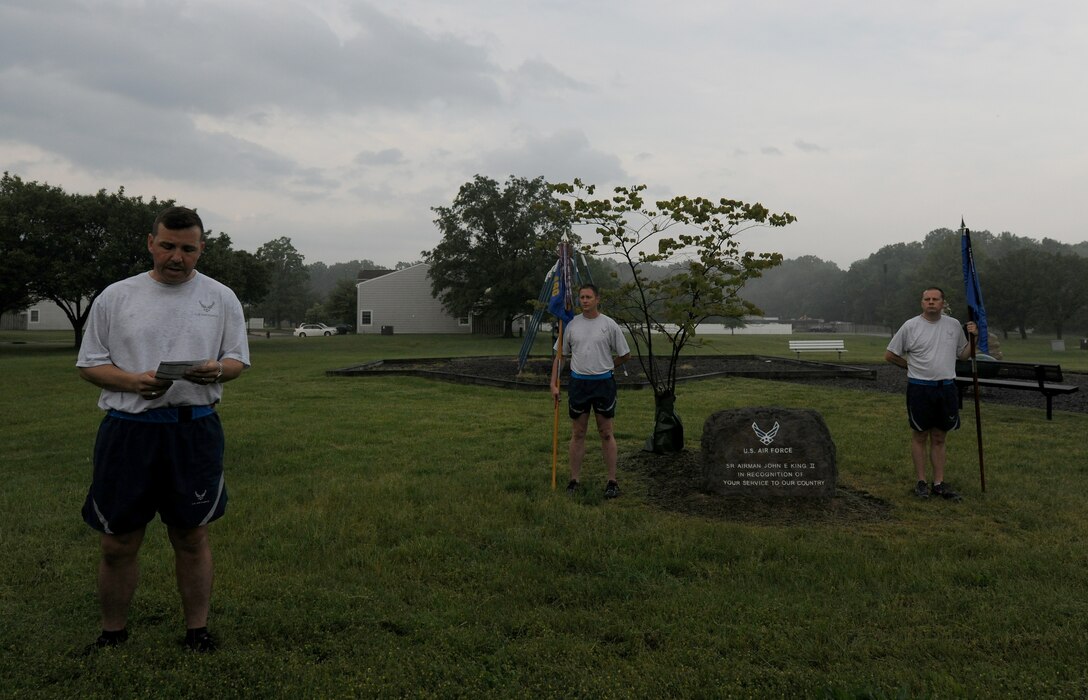 Chief Master Sgt. Patrick Shaw reads the names of the air transportation airmen who have passed in 2013 during the Port Dawg Memorial Run at Joint Base Andrews, Md., May 22, 2014. Senior Airman John E. King II, one of the 15, died on duty at JBA and has had memorial stone placed in his memory.   Shaw is the superintendent of the 89th Aerial Operations Port Squadron. (U.S. Air Force photo/ Senior Airman Nesha Humes)