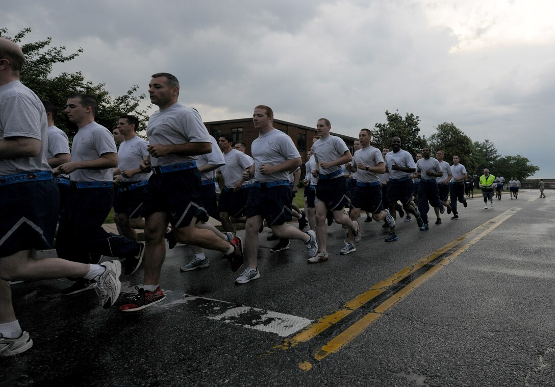 Airmen of the 89th Air Lift Wing start the first leg of the Port Dawg Memorial Run at Joint Base Andrews, Md., May 22, 2014.  The run was held in remembrance of Senior Airman John E. King II, a former 89th airman, along with 14 other air transportation airmen who have passed Air Force wide in 2013. King died while on duty on Feb. 17, 2013. (U.S. Air Force photo/ Senior Airman Nesha Humes)