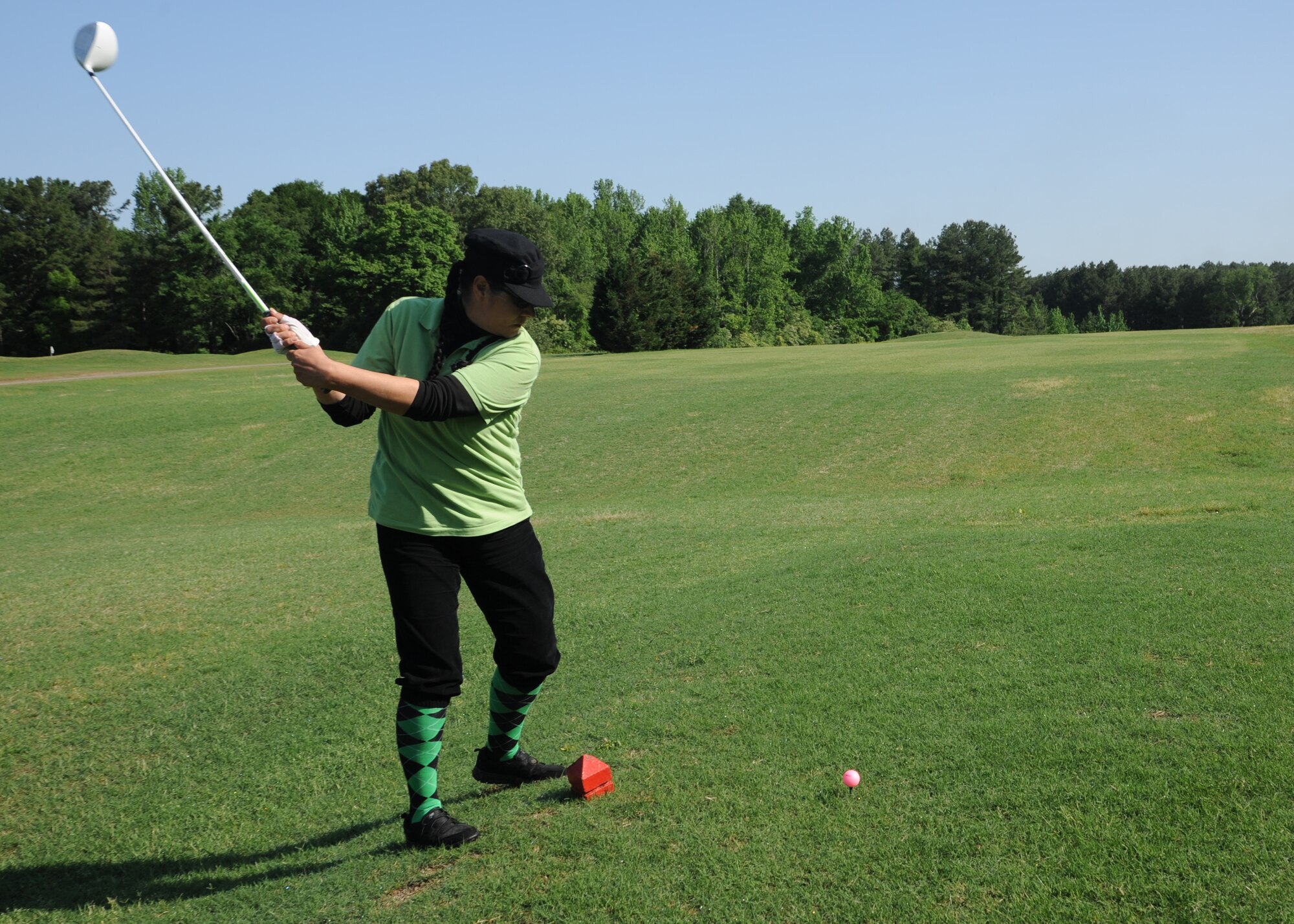 Staff Sgt. Gina Way, 19th Security Forces Squadron noncommissioned officer in charge of the visitor center, drives a golf ball May 15, 2014, at the Deer Run Golf Course at Little Rock Air Force Base, Ark. Way was part of the National Police Week golf tournament which included military and civilian police officers. (U.S. Air Force photo by Airman 1st Class Harry Brexel)