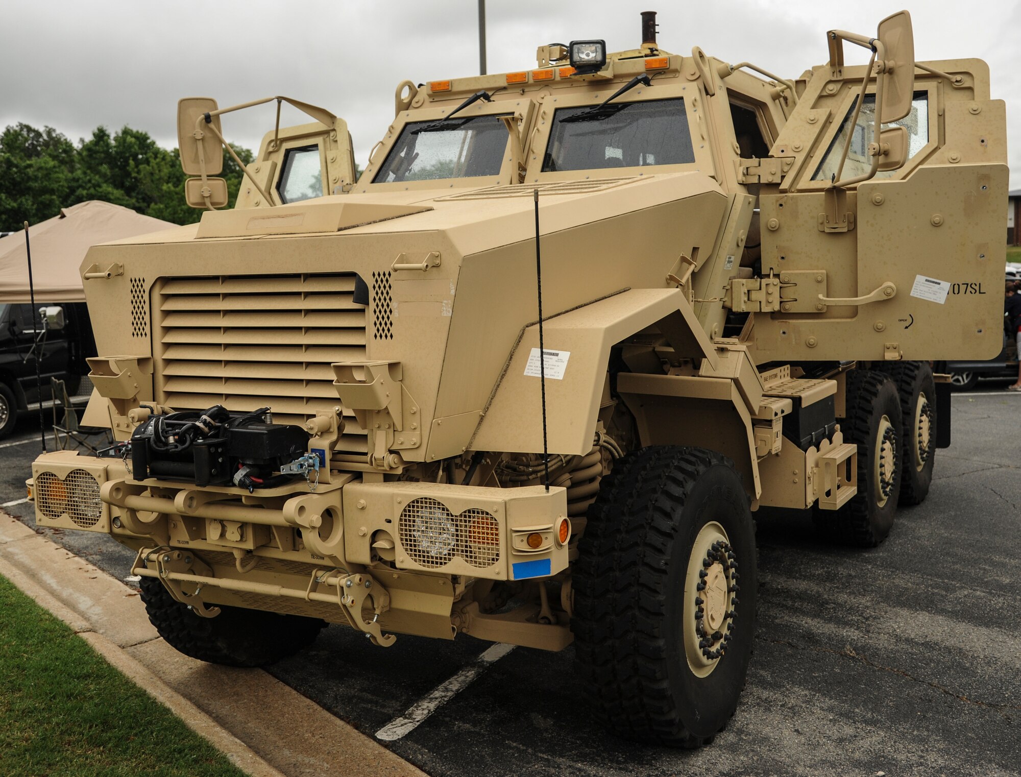 A Mine-Resistant Ambush Protected vehicle sits alongside other law enforcement vehicles as part of National Police Week May 13, 2014, at Little Rock Air Force Base, Ark. This military vehicle now belongs to Jacksonville Police Department’s special weapons and tactics team. (U.S. Air Force photo by Airman 1st Class Harry Brexel)