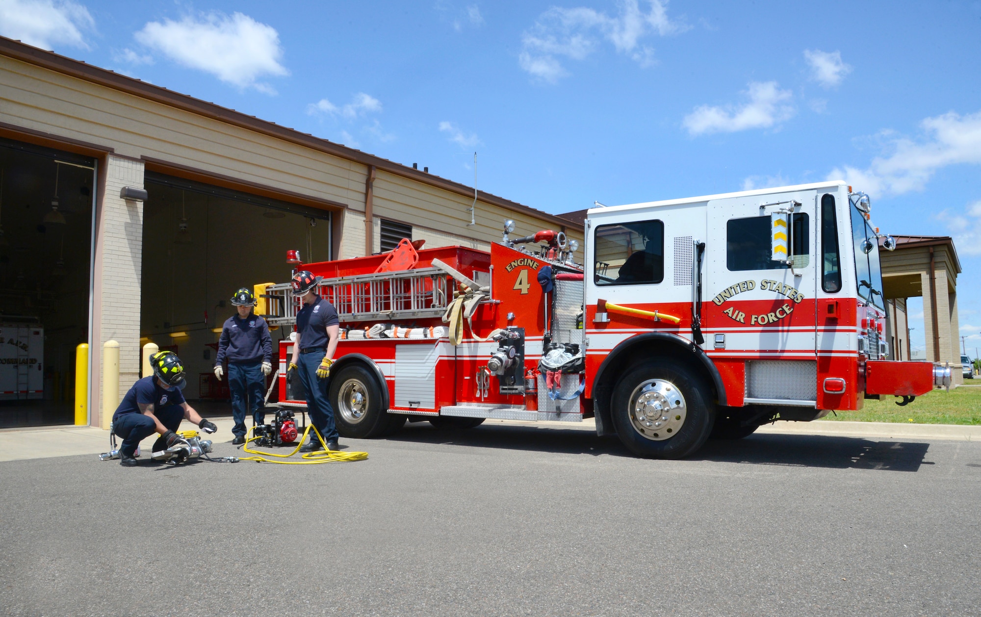 Capt. Tim Ward, Lt. David Jones and Lt. Jeff Briley perform a routine inspection on tools used for automobile extrication to assure they are working properly. The firemen are members of the new Fire Station 4, which was recently activated thanks to the firemen’s self-help work to get the station up and running quickly. (Air Force photo by Kelly White)