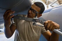 Airman 1st Class Jonathan T. Palacios-Conde, 108th Wing Aircraft Maintenance Squadron, New Jersey Air National Guard, removes screws from a leading edge panel during a phase inspection of a KC-135R Stratotanker May 20, 2014, at Joint Base McGuire-Dix-Lakehurst, N.J. (U.S. Air National Guard photo by Master Sgt. Mark C. Olsen/Released)