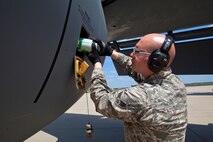 Senior Airman Anthony L. Caramiello, 108th Wing Maintenance Squadron, New Jersey Air National Guard, tops off the engine oil on a KC-135R Stratotanker May 20, 2014, at Joint Base McGuire-Dix-Lakehurst, N.J. (U.S. Air National Guard photo by Master Sgt. Mark C. Olsen/Released)
