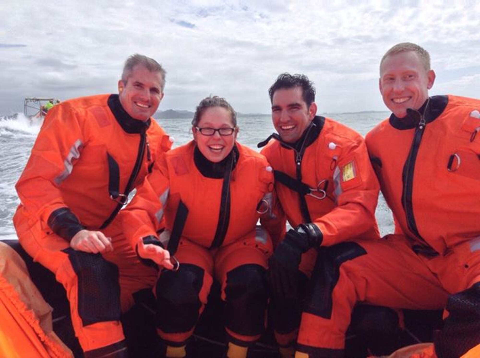 From left, Maj. Kevin Catron, Staff Sgt. Jennifer Thaxton, Capt. Morgan Cowle and Tech. Sgt. Tim Carlsrud, all from the 426th Air Base Squadron at Stavanger, Norway, smile after getting lowered into an emergency life raft in the North Sea May 13, 2014. The Airmen volunteered to serve as stranded seafarers in a training exercise with the Royal Norwegian Air Force 330th Rescue Squadron. (Courtesy photo/Released)