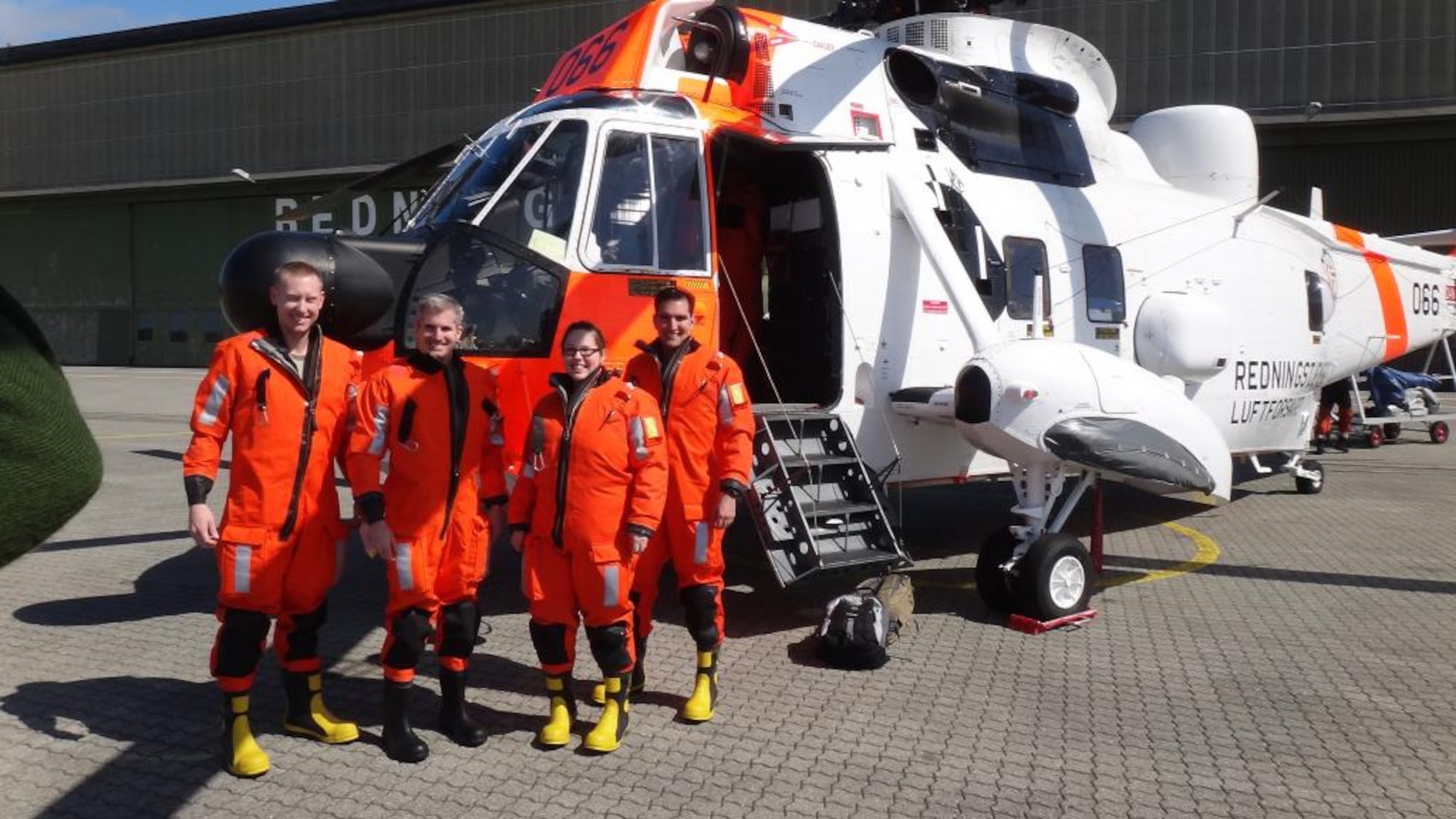 From left, Tech. Sgt. Tim Carlsrud, Maj. Kevin Catron, Staff Sgt. Jennifer Thaxton and Capt. Morgan Cowle, all from the 426th Air Base Squadron at Stavanger, Norway, pose in front of a Royal Norwegian Air Force Mk43B Sea King in their dry suits before being ferried out to an emergency life raft in the North Sea for a training exercise May 13, 2014. (Courtest Photo/Released) 