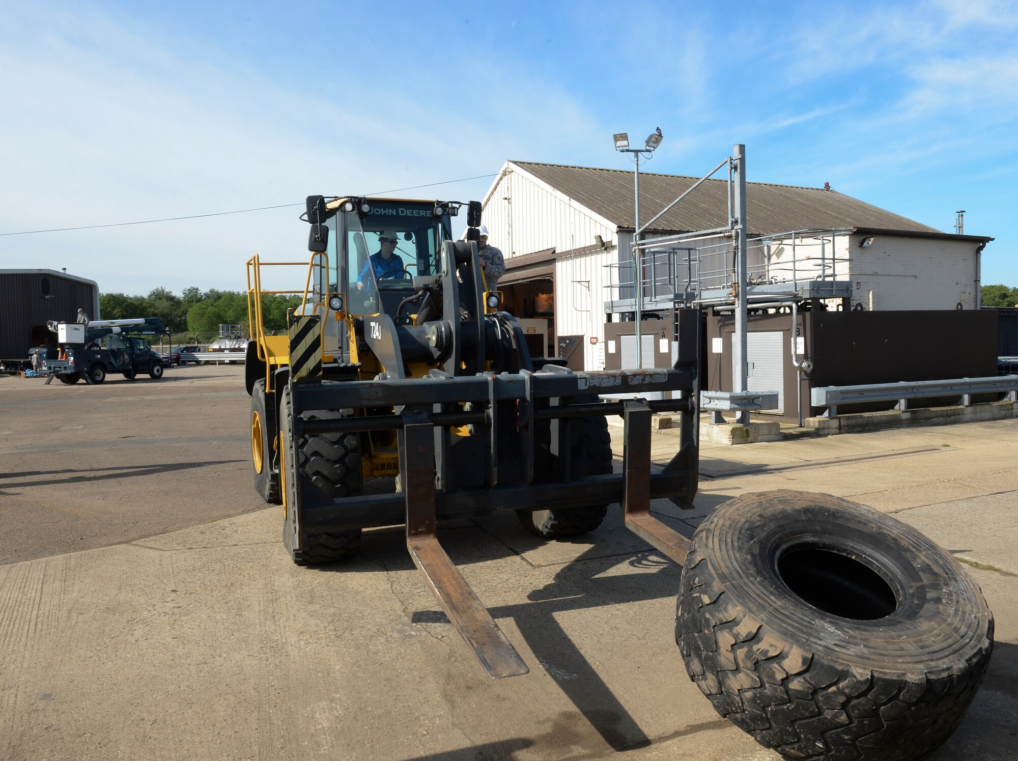 Tech. Sgt. Christopher Fisher, 48th Civil Engineer Squadron heavy equipment operator, instructs spouses on how to use a forklift during Take Your Spouse to Work Day on Royal Air Force Lakenheath, England, May 21, 2014. The event gave spouses a better knowledge of what their partners do on a daily basis and in a deployed enviroment. (U.S. Air Force photo by Airman 1st Class Nigel Sandridge/Released) 