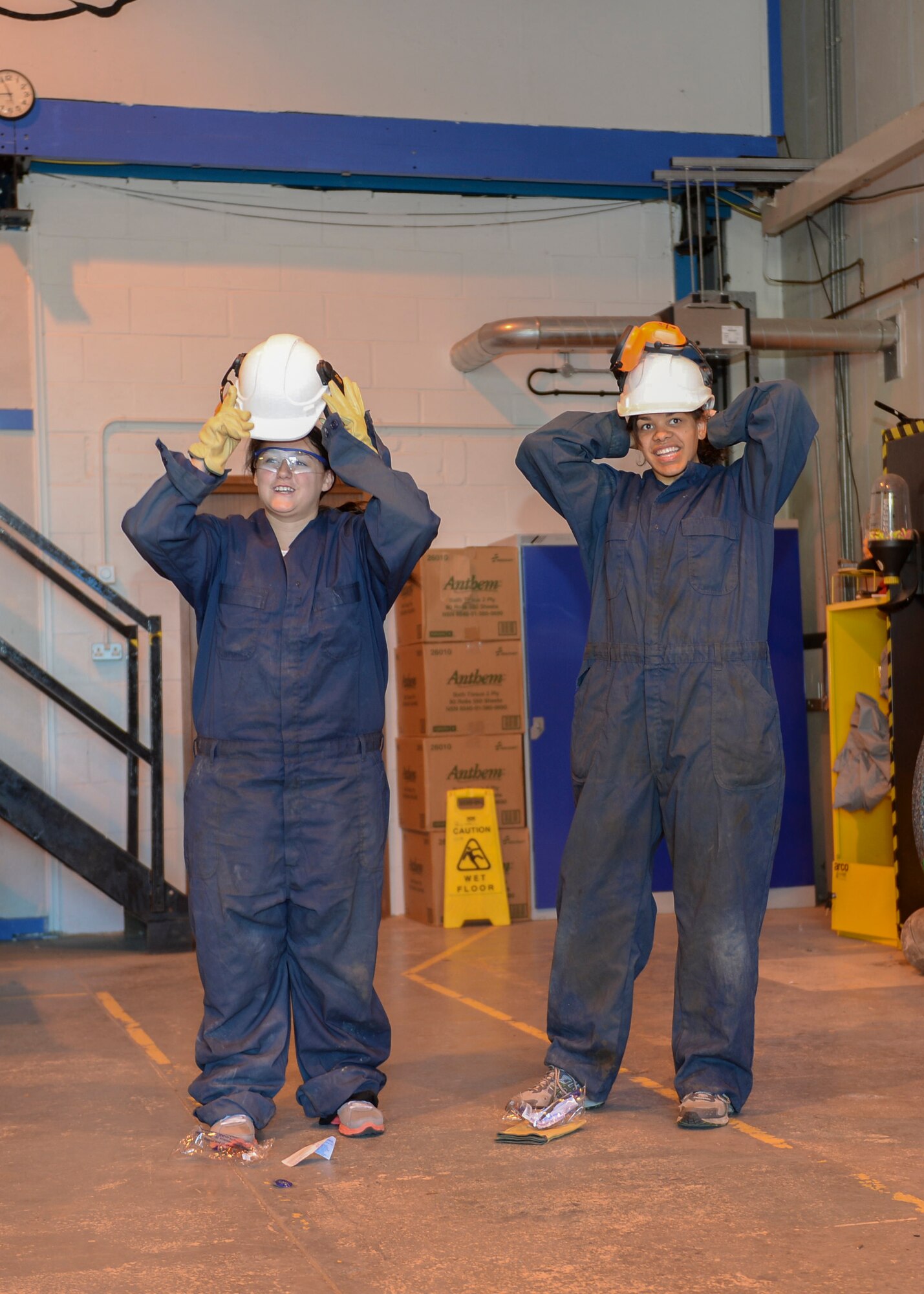 Alyssa Pfeifer, left, wife of Airman 1st Class Bryan Pfeifer, and Sarah Hade, wife of Airman Cody Hade, 48th Civil Engineer Squadron heavy equipment operators, suit up for construction exercises during Take Your Spouse to Work Day on Royal Air Force Lakenheath, England, May 21, 2014. All spouses were provided the proper protective equipment for all events throughout the day. (U.S. Air Force photo by Airman 1st Class Nigel Sandridge/Released)