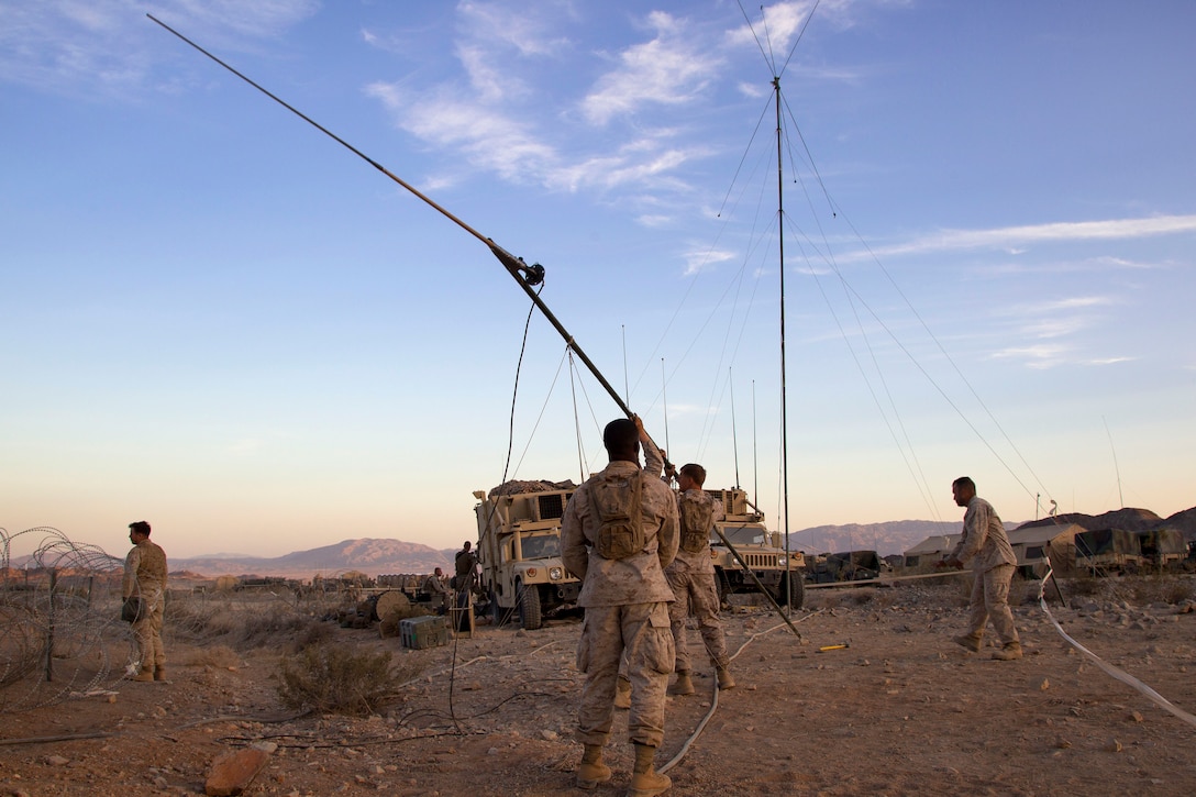 Marines setup a field expedient antenna during Exercise Desert Scimitar 2014 on Marine Corps Air Ground Combat Center Twentynine Palms, Calif., May 12, 2014.