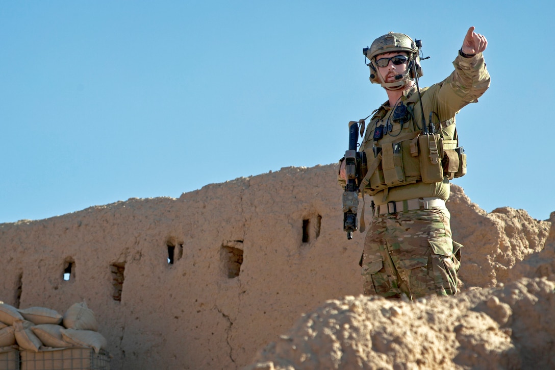 A coalition force member provides security during a patrol with Afghan local police near Khost village in Afghanistan's Farah province, Nov. 2, 2012.  
