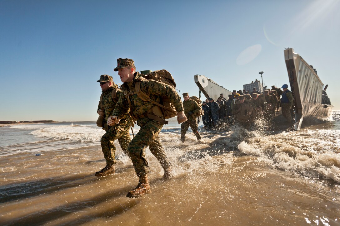 Marines and sailors assigned to the 26th Marine Expeditionary Unit step off a landing craft utility vehicle onto the shore of Breezy Point, a small coastal community in New York, Nov. 9, 2012. They and troops from other units are partnering with the Federal Emergency Management Agency, the U.S. Army Corps of Engineers and the National Guard to help the residents of New York City return to normalcy as soon as possible.  
