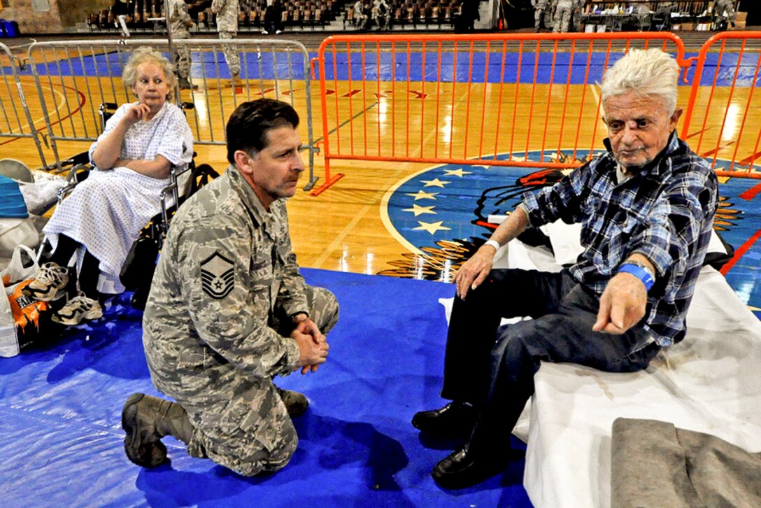 Air Force Master Sgt. Steven Sabato listens to a request by a displaced resident at a shelter in Jersey City, Nov. 7, 2012. New Jersey National Guardsmen are helping displaced residents at the Jersey City armory in the aftermath of Hurricane Sandy. Sabato is assigned to the 108th Wing, New Jersey Air National Guard.  
