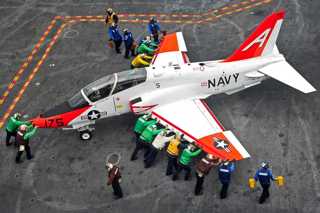 U.S. Navy sailors push back a T-45C Goshawk training aircraft on the flight deck of the aircraft carrier USS Harry S. Truman in the Atlantic Ocean, Nov. 6, 2012. The Harry S. Truman is under way supporting carrier qualifications. The aircraft is assigned to Training Squadron 7.  
