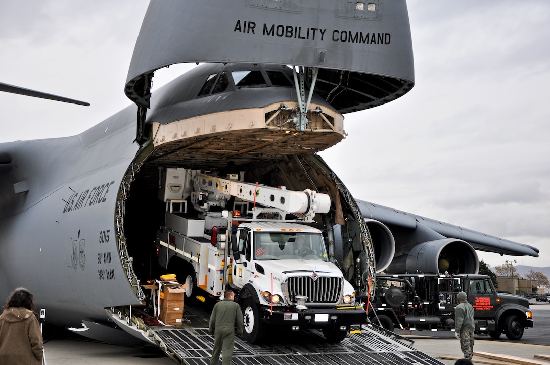 Air Force crews offload Southern California Edison power repair equipment from a C-5 Galaxy on Stewart Air National Guard Base in Newburgh, N.Y., Nov. 1, 2012. The Defense Department initiated the airlift operation to aid recovery efforts in Hurricane Sandy's aftermath.  
