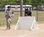 Staff Sgt. Lino Estacion and Demon complete a portion of an agility course during the Western States Police Canine Association trial at Travis Air Force Base, Calif. A total of 66 competitors participated from 29 different agencies in the trial. Estacion and Demon are with the 60th Security Forces Squadron. (U.S. Air Force photo/Senior Airman Nicole Leidholm)