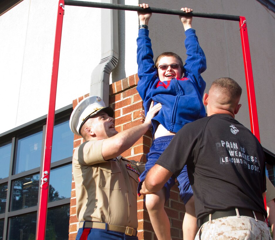 (Left) Maj. Derek Nielsen, commanding officer of Recruiting Station Columbia lifts Richard Shure, a Chicago, Ill. native onto the pull up during the Atlantic Coast Conference Women’s Rowing Championship, May 16th, at Lake Hartwell in Clemson, S.C. The Marine Corps was recognized as the “Presenting Partner” for the 2014 ACC Women’s Rowing Championship. Marines from Recruiting Station Columbia showed their support and talked to students and spectators in an effort to build community relations and expand on the Marine Corps mission of diversity recruiting. (U.S. Marine Corps photo by Cpl. Stanley Cao)