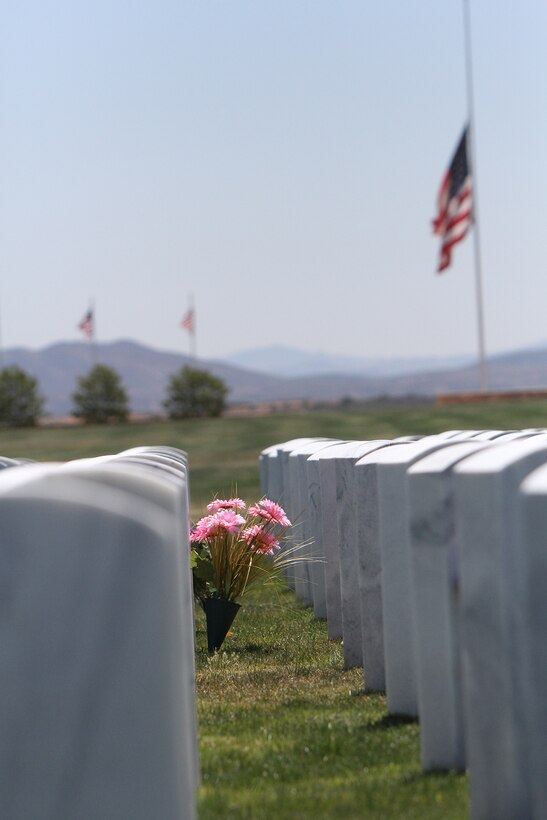 Flowers break the pattern of headstones as the American flag flies at half-staff at the Miramar National Cemetery in San Diego, May 15. The cemetery serves as an annex to the Fort Rosecrans National Cemetery and was dedicated January 2010.