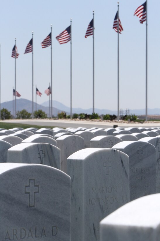 American flags wave in the distance over headstones at the Miramar National Cemetery in San Diego, May 15. The cemetery serves as an annex to the Fort Rosecrans National Cemetery and was dedicated January 2010. 