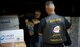 Rob Wilkins, front, and Walt Sides inspect a recent shipment of 2014 souvenir t-shirts for the Rolling Thunder motorcycle demonstration event May 15, 2014 at Sides' farm outside Leesburg, Va. Wilkins is head of Rolling Thunder Magazine and a retired Air Force master sergeant. Sides, a retired Marine first sergeant, original co-founder and executive director of Rolling Thunder, has organized the event since 1988. (U.S. Air Force photo/Senior Airman Alexander W. Riedel)
