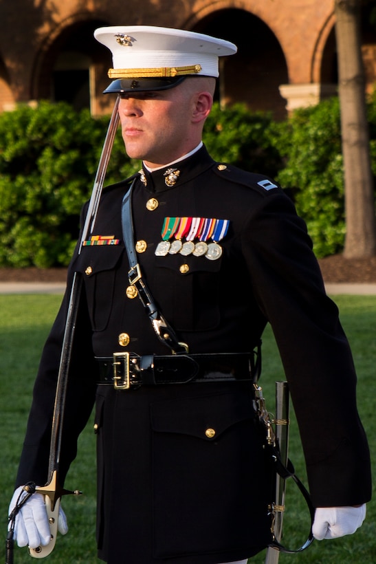 Capt. John Auer, U.S. Marine Corps Silent Drill Platoon commander, performs during a ceremony at Marine Barracks Washington, D.C., May 22, 2014. The ceremony was held so Gen. James Amos, commandant of the Marine Corps, and Sgt. Maj. Michael Barrett, sergeant major of the Marine Corps, could present the silver brass uniform items to the rifle inspector and platoon commander. (Official Marine Corps photo by Cpl. Dan Hosack/Released)