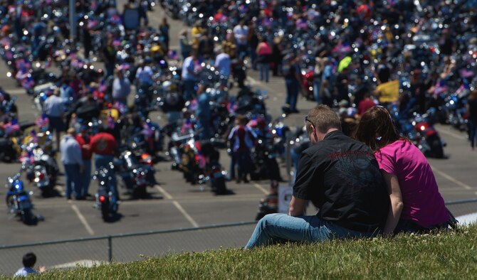 A couple enjoys the sun and view on thousands of motorcycles staged for the 26th Rolling Thunder motorcycle run, May 26, 2013 in Washington, D.C. The rally is intended to raise awareness of the prisoners of war and missing in action personnel of the nation's military on the occasion of Memorial Day. (U.S. Air Force photo/Senior Airman Alexander W. Riedel)
