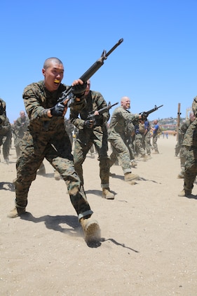Recruits of Company I, 3rd Recruit Training Battalion, execute bayonet techniques during a Marine Corps Martial Arts Program class aboard Marine Corps Recruit Depot San Diego Calif., May 14. During the event, recruits were taught to perform a horizontal and vertical butt stroke, vertical and horizontal slash, disrupt, and offensive and defensive weapon maneuvers.