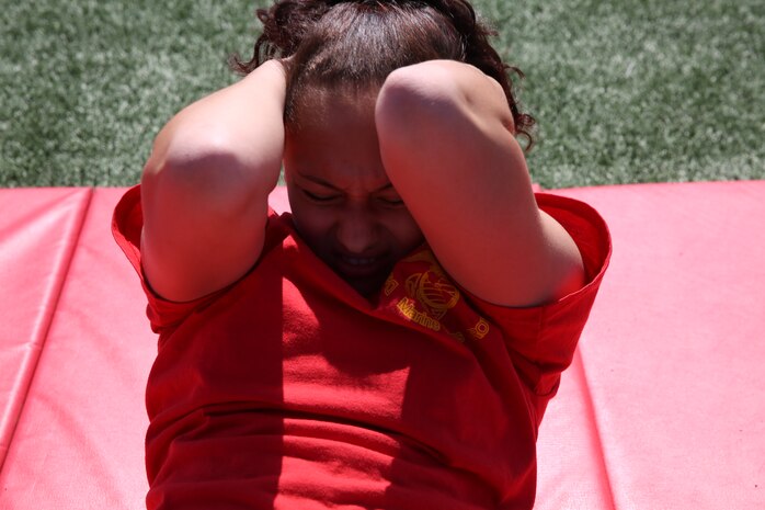 Lauren Hess executes sit-ups for two minutes during The National High School Physical Fitness Championships aboard Marine Corps Recruit Depot San Diego, May 16-17. To earn a spot at the National High School Physical Fitness Championships, teams had to attain a qualifying score at state level.