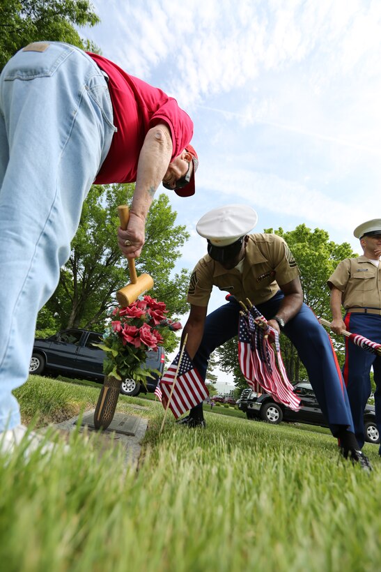 Mr. Charlie Barnes and Gunnery Sgt. Timothy Ussery place a flag at a fallen servicemembers grave May 21 at Mt. Moriah and Freeman Funeral Home in Kansas City, Mo. The Simpson Hoggat Marine Corps league will also host an event for family membersr of the fallen Monday May 26. 