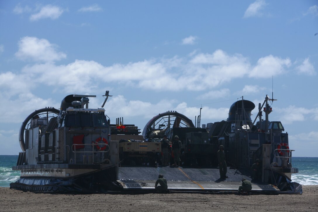 Sailors from Amphibious Squadron 5 (PHIBRON 5), prepare to off-load vehicles from a landing craft air cushion during ship-to-shore operations as part of Composite Training Unit Exercise (COMPTUEX) at Camp Pendleton, Calif., May 20, 2014. The 11th Marine Expeditionary Unit and PHIBRON 5 team conduct COMPTUEX to hone mission essential tasks, execute specified MEU and ARG operations, and establish the foundation for a cohesive warfighting team for future exercises and operations. (U.S. Marine Corps photo by Cpl. Jonathan R. Waldman/Released)