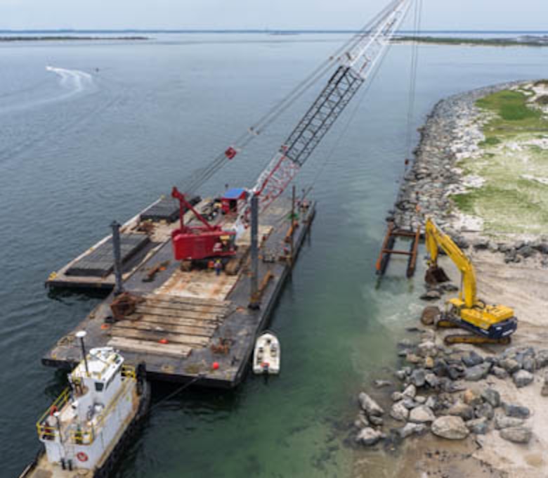 A crane lowers a marine mattress as part of Barnegat Inlet north jetty repair work in May of 2014. The U.S. Army Corps of Engineers' Philadelphia District is repairing the north jetty from damages sustained during Hurricane Sandy. 